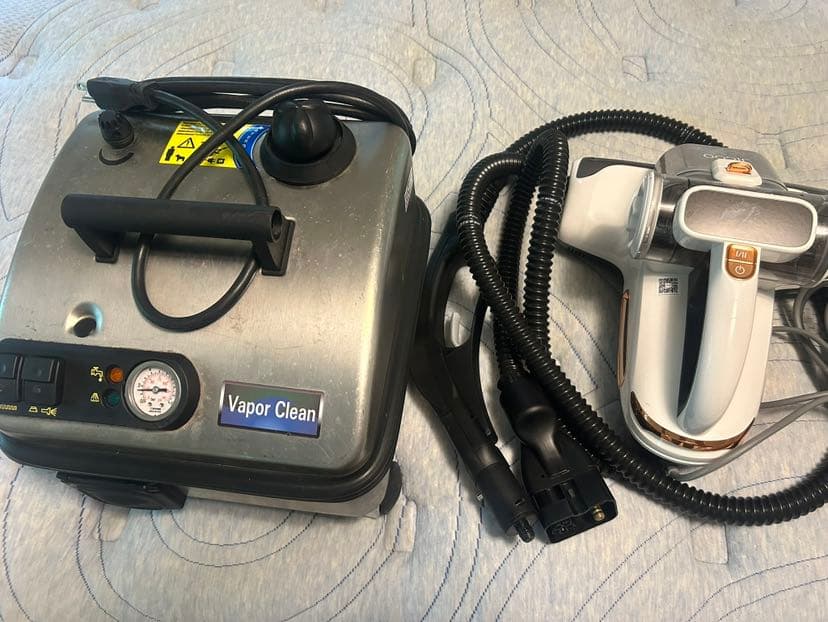 Vapor clean steam cleaner standing beside a mattress vacuum with UV-C light